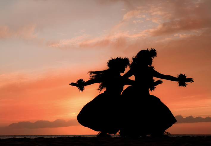 Two women perform a hula dance