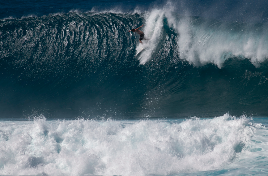 Surfer riding a large winter wave on Oahu's North Shore Surfer riding a large winter wave on Oahu's North Shore