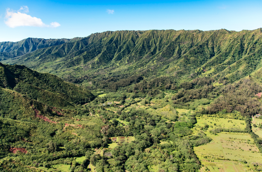 Helicopter flying over green valleys and sea cliffs on Oahu Helicopter flying over green valleys and sea cliffs on Oahu